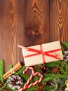 Christmas and Happy New Year dark brown background. Gift Christmas box, wooden table, top view, copy space, vertical. Royalty Free Stock Photo