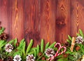 Christmas and Happy New Year dark brown background. Top view, copy space, wooden rustic table, fir branches Royalty Free Stock Photo