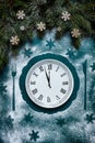 Christmas and Happy New Year Festive background with fir tree branches, christmas decoration and dish with clock pattern that