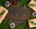 Christmas and Happy New Year zero waste backdrop. Dark wooden table. Handmade gift Christmas box, fir branches, craft paper , top Royalty Free Stock Photo