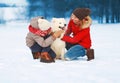 Christmas happy smiling family, mother and son child walking with white Samoyed dog on snow in winter da Royalty Free Stock Photo