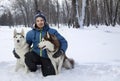 Christmas happy teenager boy playing with white Husky dog in winter day, dog and child on snow Royalty Free Stock Photo