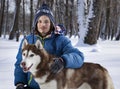 Christmas happy teenager boy playing with white Husky dog in winter day, dog and child on snow Royalty Free Stock Photo
