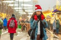 Christmas hat, Asian girl in the city street with snow. Happy girl laughing. Royalty Free Stock Photo