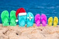 Christmas hat on flip flops in the sand of a beach Royalty Free Stock Photo