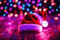 Christmas hat on the floor with bright lights around, xmas wallpaper