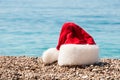 Christmas hat lies on the beach.