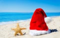 Christmas hat with starfish on the beach Royalty Free Stock Photo