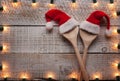 Christmas hats on wooden spoons framed by decorative lights Royalty Free Stock Photo