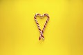 Christmas heart made of sweets on a yellow background. Flat lay, place for text Royalty Free Stock Photo
