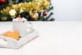 Christmas heart shaped gingerbread cookies or pepparkakor with cup of hot chocolate, on white wooden table with christmas tree on