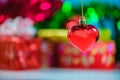 Christmas heart shaped red ball and blurred Christmas decoration Royalty Free Stock Photo