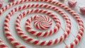 Red and white striped candy canes are arranged in a spiral pattern on a light-colored wooden surface. Royalty Free Stock Photo