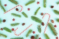 Christmas holiday background with candy cane, fir branches, pine cones and red stars, wintertime season Royalty Free Stock Photo