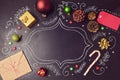 Christmas holiday background with decorations and hand drawings on chalkboard. View from above Royalty Free Stock Photo