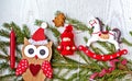 Christmas holiday background with Christmas decorations, owl in Santa hat, toy horse on a light wooden table. Top view Royalty Free Stock Photo
