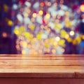 Christmas holiday background with empty wooden deck table over beautiful bokeh Royalty Free Stock Photo