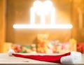 Christmas holiday background with empty wooden table top and christmas hat  over festive bokeh light xmas gift box Royalty Free Stock Photo