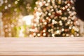 Christmas holiday background with empty wooden table top over festive bokeh light Royalty Free Stock Photo