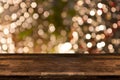 Christmas holiday background with empty wooden table top over festive bokeh light Royalty Free Stock Photo