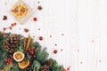 Christmas holiday background with fir tree decorated with pine cone, cinnamon sticks and a gift wrapped in kraft paper Royalty Free Stock Photo