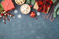 Christmas holiday background with gift boxes and hot chocolate cup on blackboard Royalty Free Stock Photo