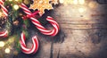 Christmas holiday background with gingerbread cookies, candy cane and evergreens border Royalty Free Stock Photo