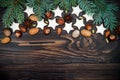 Christmas holiday background with gingerbread cookies and fir branches on the old wooden board. Copy space Royalty Free Stock Photo