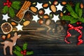 Christmas holiday background with gingerbread cookies and fir branches on the old wooden board. Copy space Royalty Free Stock Photo