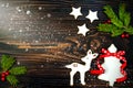 Christmas holiday background with gingerbread cookies and fir branches on the old wooden board. Copy space Royalty Free Stock Photo