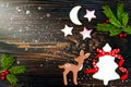 Christmas holiday background with gingerbread cookies, spices and fir branches on the old wooden board. Copy space Royalty Free Stock Photo