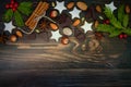 Christmas holiday background with gingerbread cookies, spices and fir branches on the old wooden board. Copy space Royalty Free Stock Photo