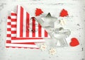 Christmas Holiday background with red and white theme cookie cutters on white wood. Royalty Free Stock Photo