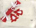 Christmas Holiday background with red and white theme handmade fabric bon-bon cracker with felt decorations on vintage shabby chic