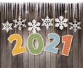 Christmas holiday background with snowflakes and icicles in front of a wooden wall Royalty Free Stock Photo