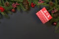 Christmas holiday background - tree, gifts, holly berries and decoration on black chackboard. Holiday card with copy space. Top vi Royalty Free Stock Photo