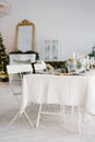 Christmas holiday beautifully set table in a spacious bright dining room or living room in the house Royalty Free Stock Photo