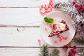 Christmas holiday candy cane chocolate cheesecake, above view side border over a white wood background Royalty Free Stock Photo