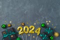 Christmas holiday concept with 2024 new year, decorations, gift boxes and ornaments on dark background. Top view, flat lay