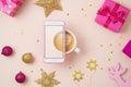 Christmas holiday creative concept with coffee cup, smart phone Royalty Free Stock Photo