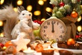 Christmas or holiday decoration background - small fir tree, retro alarm clock shows midnight and sweet food. New year still life