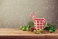 Christmas holiday decorations with checked cup and candy on wooden table Royalty Free Stock Photo