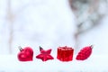Christmas holiday decorations, red heart, pine cone and gift, green branch on white blured background