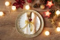 Christmas Holiday Dinner Place Setting - Plates, Napkin, Cutlery, Gold Bauble Decorations Over Oak Table Background. Fork And Royalty Free Stock Photo