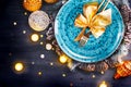 Christmas holiday dinner table setting. Xmas table decoration with blue plate, colorful decor and candles Royalty Free Stock Photo
