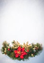 Christmas holiday faux poinsettia pine wreath with white copyspace. Royalty Free Stock Photo