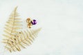 Christmas holiday festive theme with golden violet Christmas ornament and gold decorative fern leaves