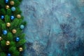 Christmas holiday frame with festive decorations blue and gold baubles on old blue background. Christmas background with copy