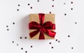 Christmas holiday gift box red bow on decorated festive table with sparkle stars Royalty Free Stock Photo