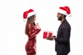 Christmas holiday happy asian couple hold present gift box wear red new year santa hat cap, indian man and asian woman love smile Royalty Free Stock Photo